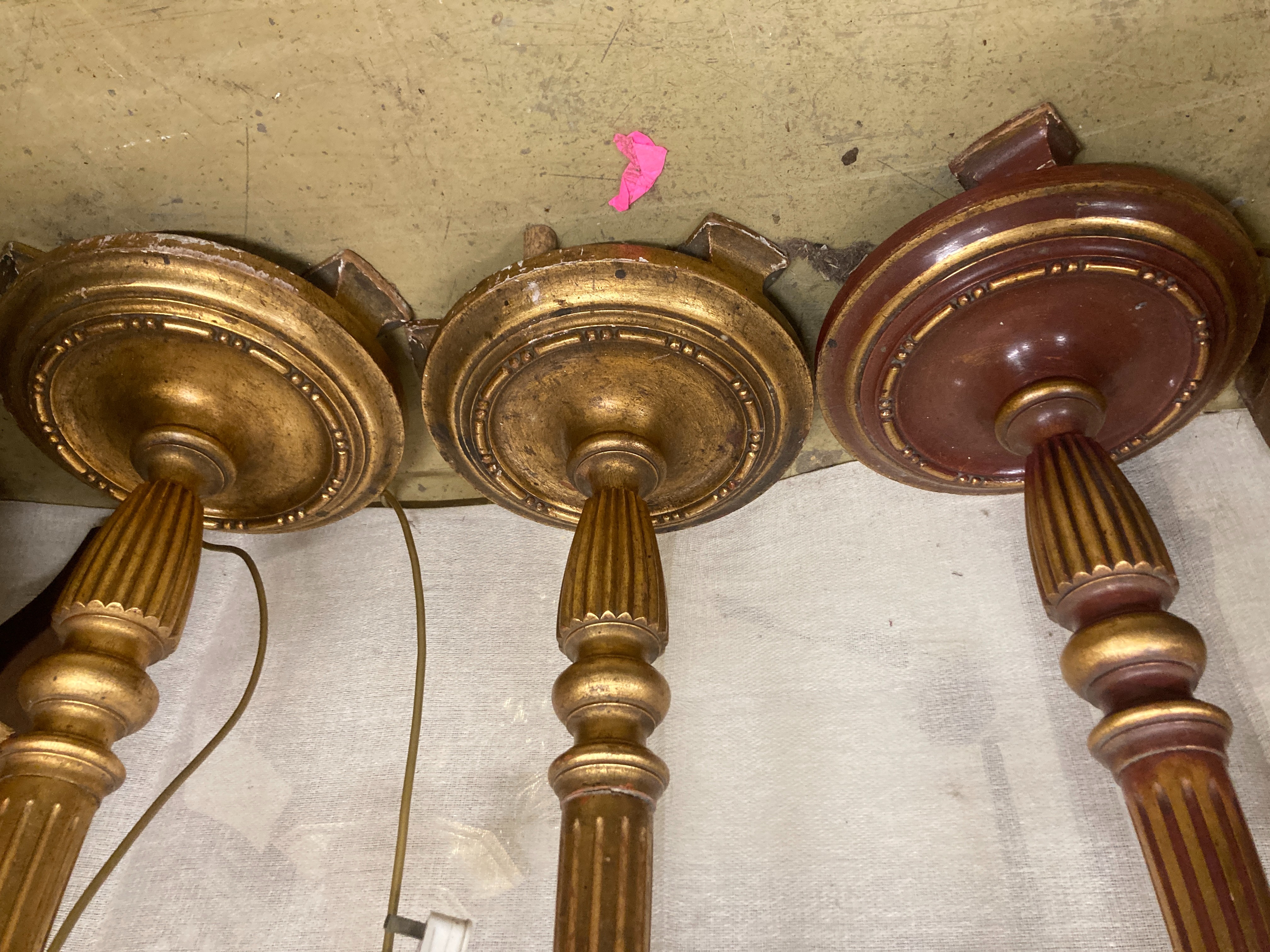 A set of three gilt carved wood lamp standards, height excluding fittings 135cm